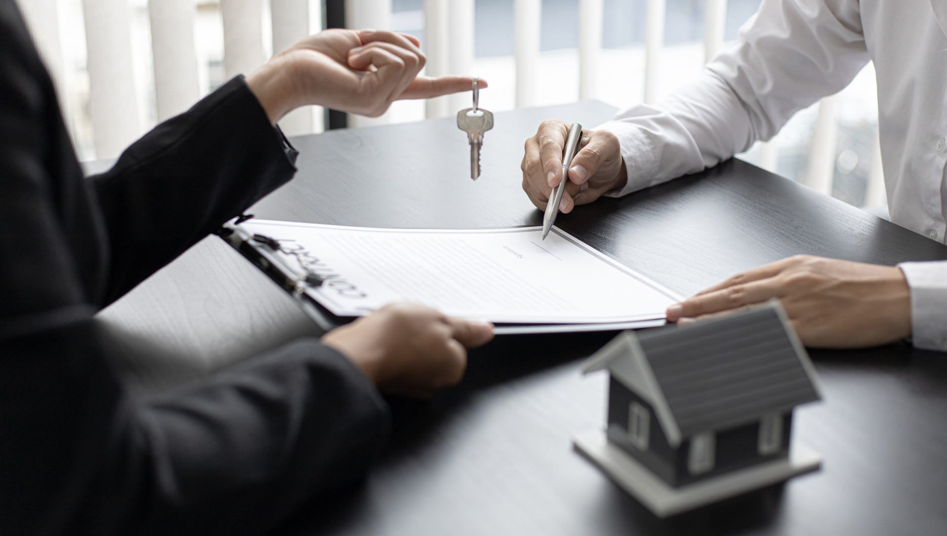 Investor Signing the Contract to Buy the House
